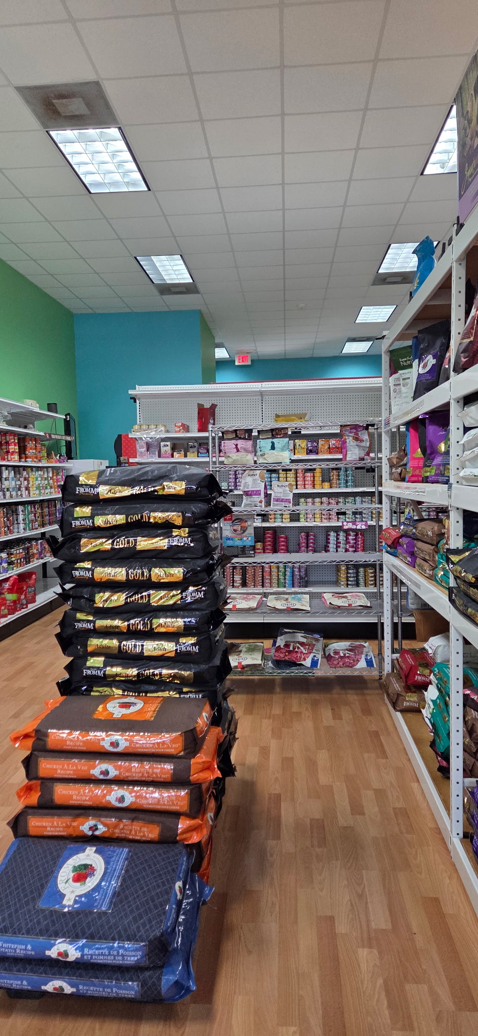 Bags of pet food and shelves of cans inside our Miami store